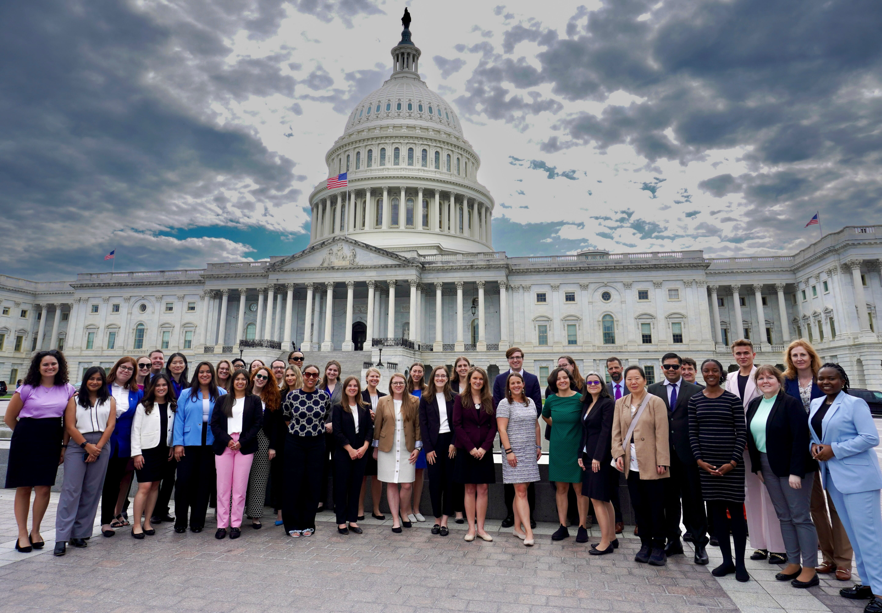 Elizabeth is pictured with her cohort at the US Capitol after visiting the Senate for meetings. She is in a purple blazer in the front row, right of center.